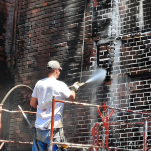 Professional_man_pressure_washing_brick